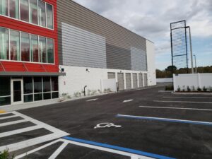 New storage facility with AutoGate VPL gates & white PVC privacy fence, installed by Peachtree Fence & Gates