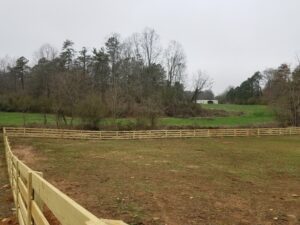 4-rail farm fence in a pasture on a horse farm in Cumming, Ga., installed by Peachtree Fence & Gates