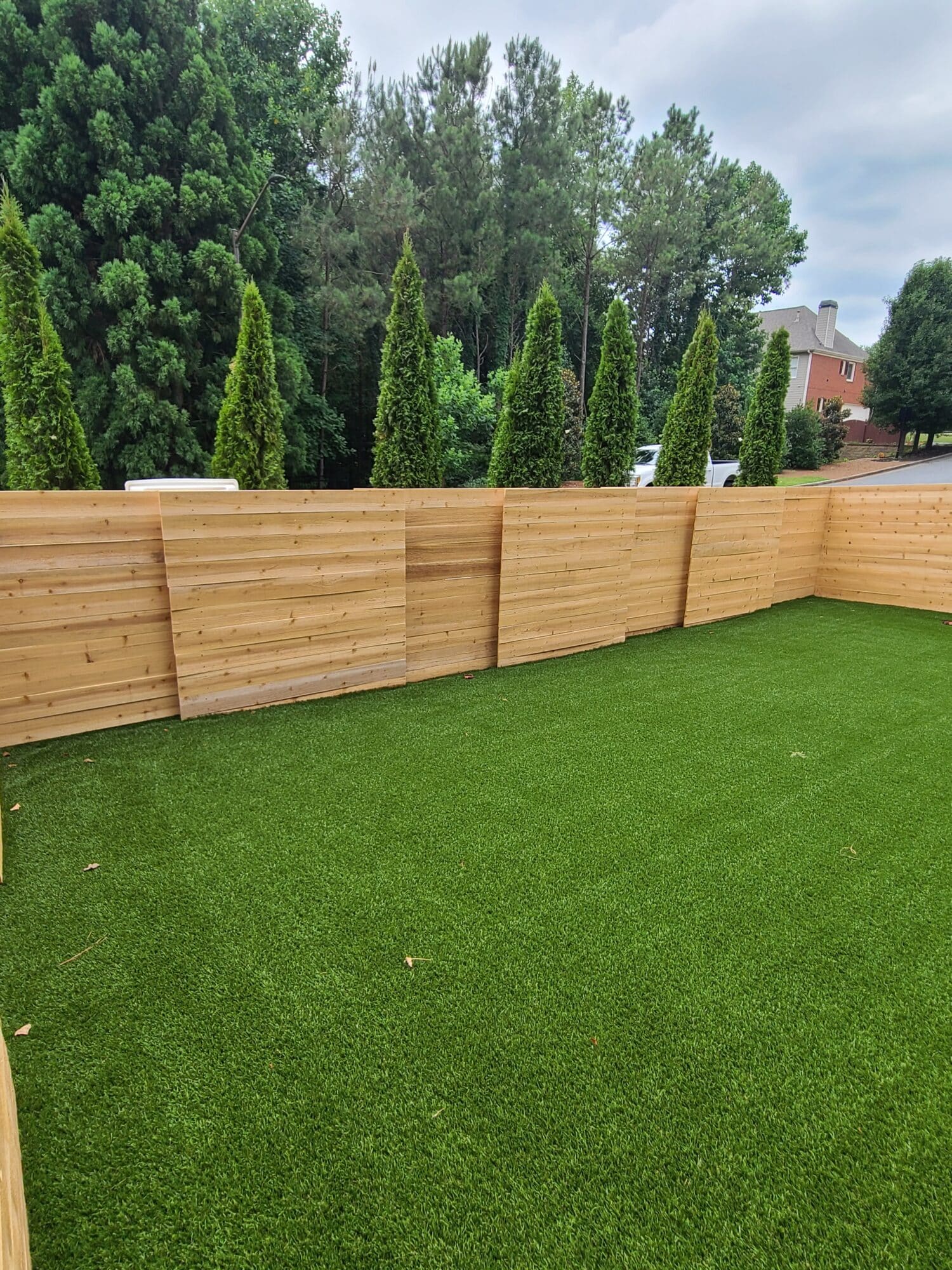 Modern horizontal privacy fence in an HOA community, installed by Peachtree Fence & Gates